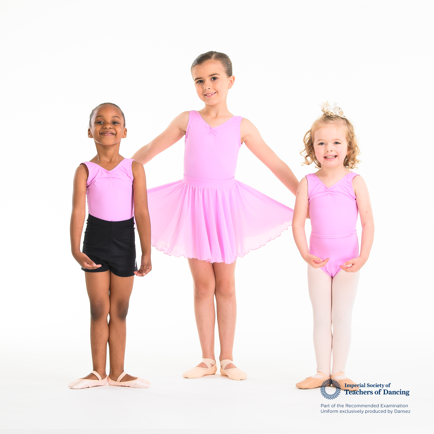 A group of young dancers wearing pink ISTD leotards and shorts