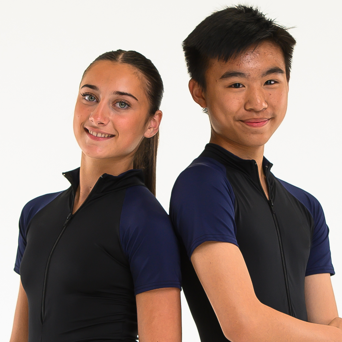 Two teenage dancers posed back to back wearing blue and black ISTD unitards