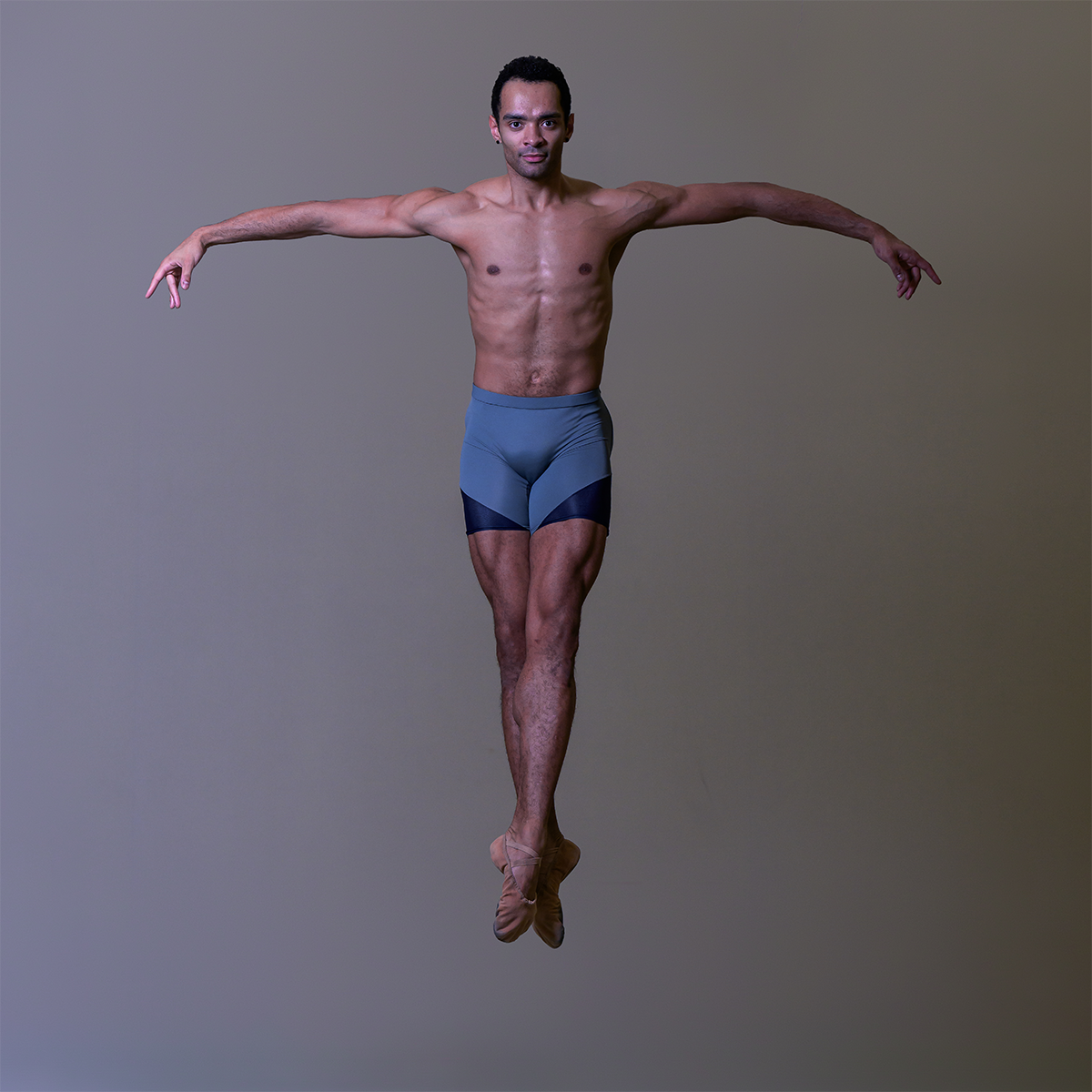 Brandon Lawrence in grey shorts leaping