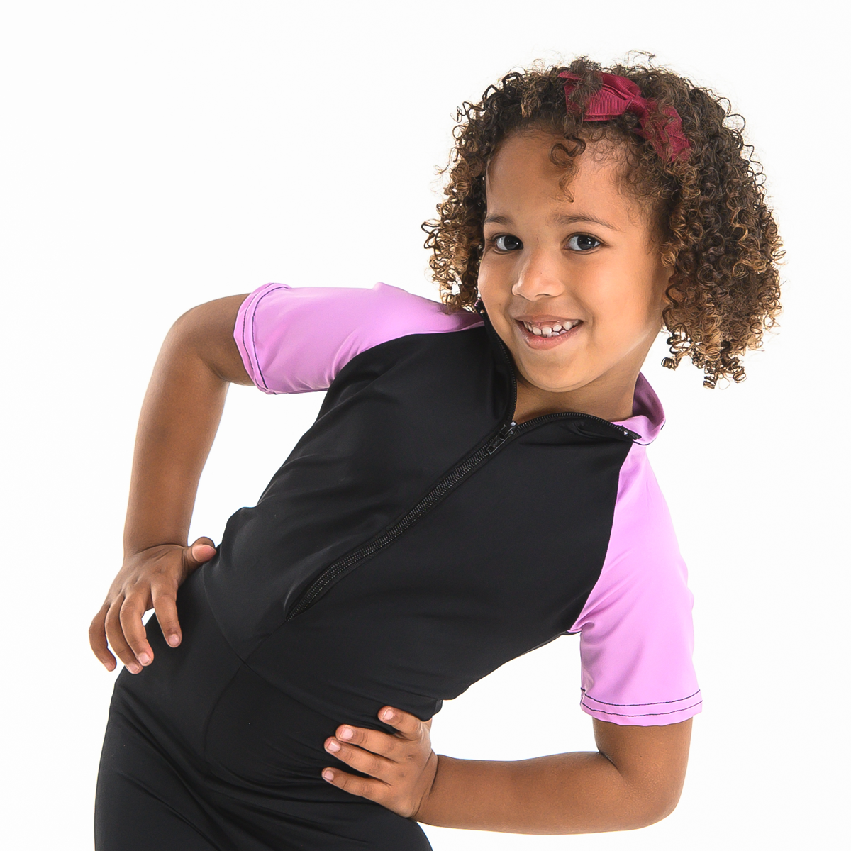 Young female dancer posed wearing the pink ISTD unitard