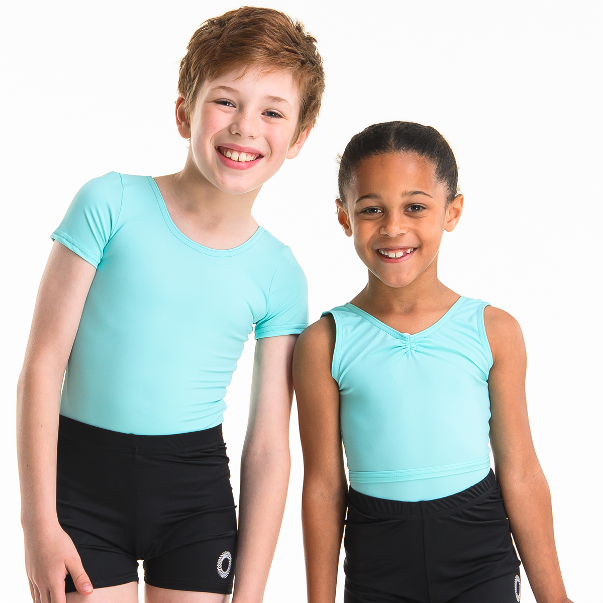A young boy and a girl wearing green ISTD leotards and black shorts
