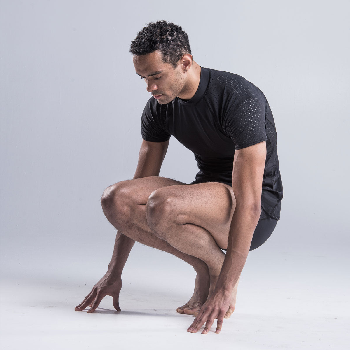 Brandon Lawrence wearing black fitted turtleneck gives style and elegance with a drop sleeve and shaped body allowing freedom of movement. A shaped perforated section down each side provide air flow throughout the top. A contrast stitch along the drop sleeve ties in with shorts and legging in the collection.