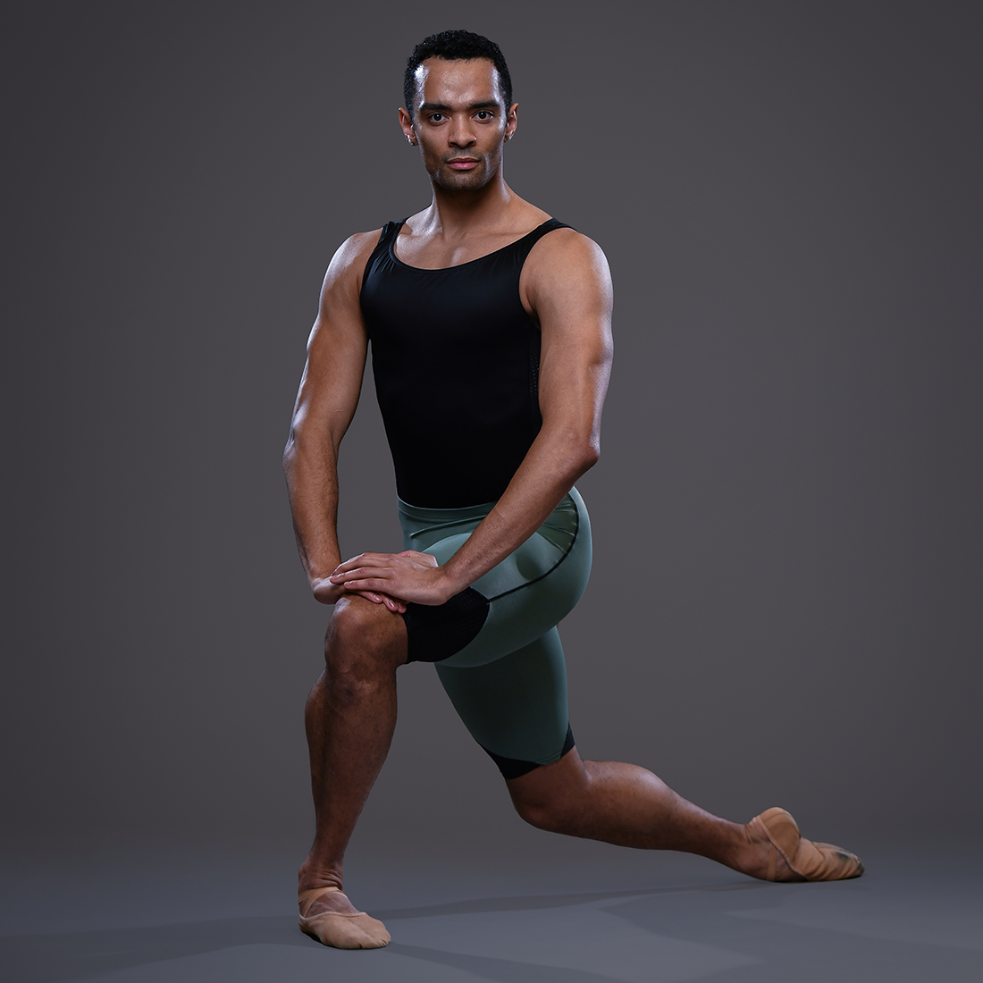 Brandon Lawrence Soloist Ballet Zurich wearing green dance shorts designed by dansez