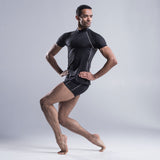 Brandon Lawrence wearing a black fitted turtleneck with a drop sleeve and shaped body allowing freedom of movement. A shaped perforated section down each side provide air flow throughout the top.  A contrast stitch along the drop sleeve  ties in with shorts and legging in the collection. 